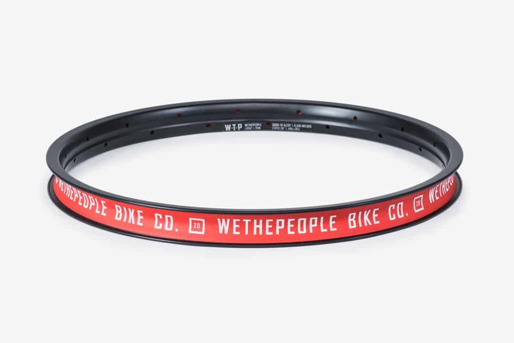 Wethepeople Logic BMX rim in black with red branding, a durable and high-performance rim designed for freestyle BMX bikes