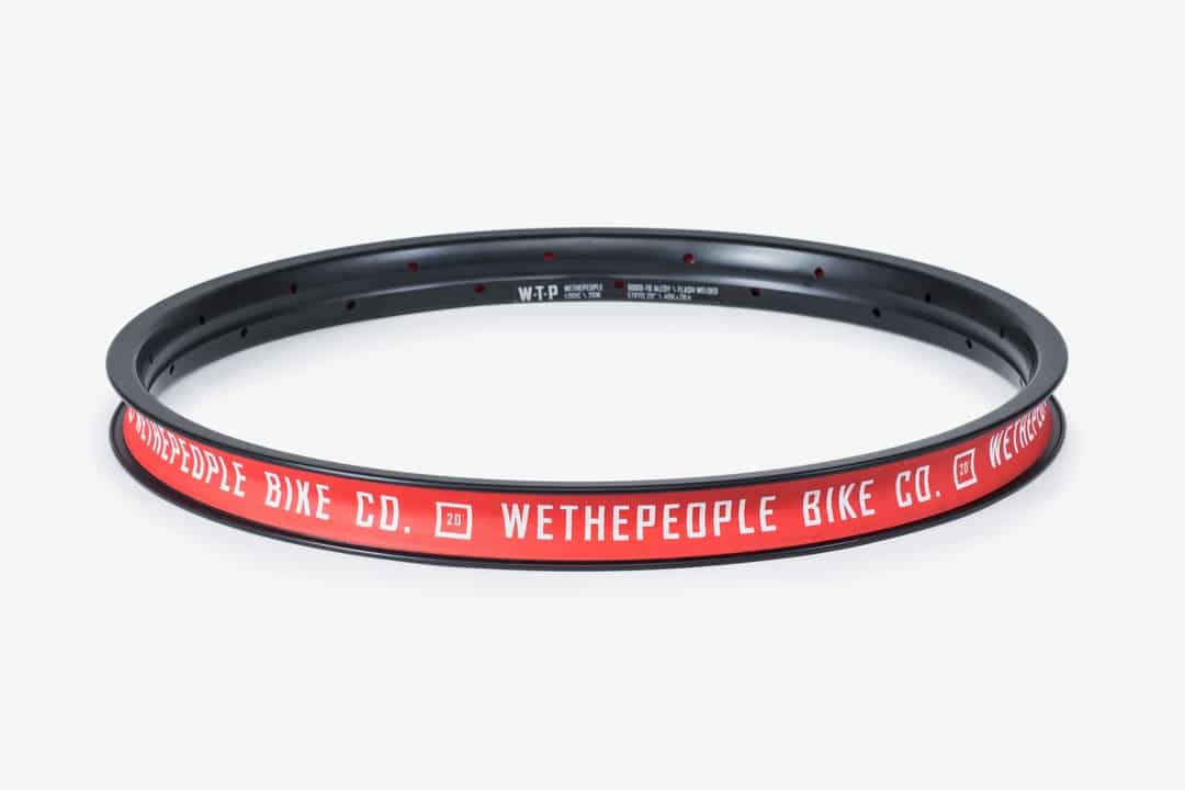 Wethepeople Logic BMX rim in black with red branding, a durable and high-performance rim designed for freestyle BMX bikes