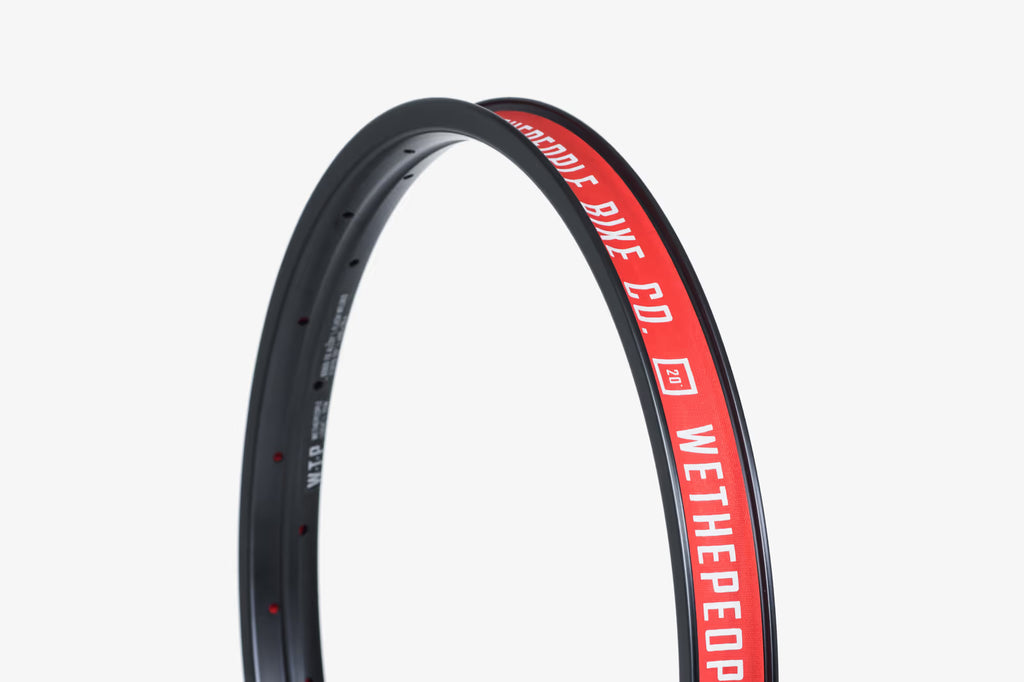 Wethepeople Logic 20" BMX rim in black with red branding, showcasing a durable double-wall design.