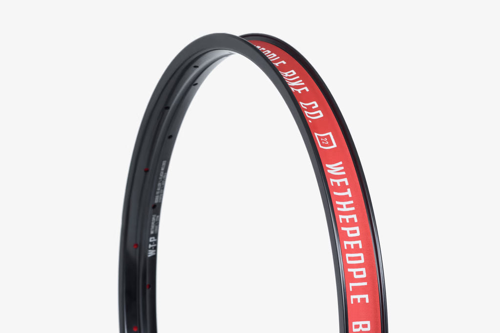 Wethepeople Logic Welded BMX Rim, 22-inch, black with red WTP logo, shown curved against a light background