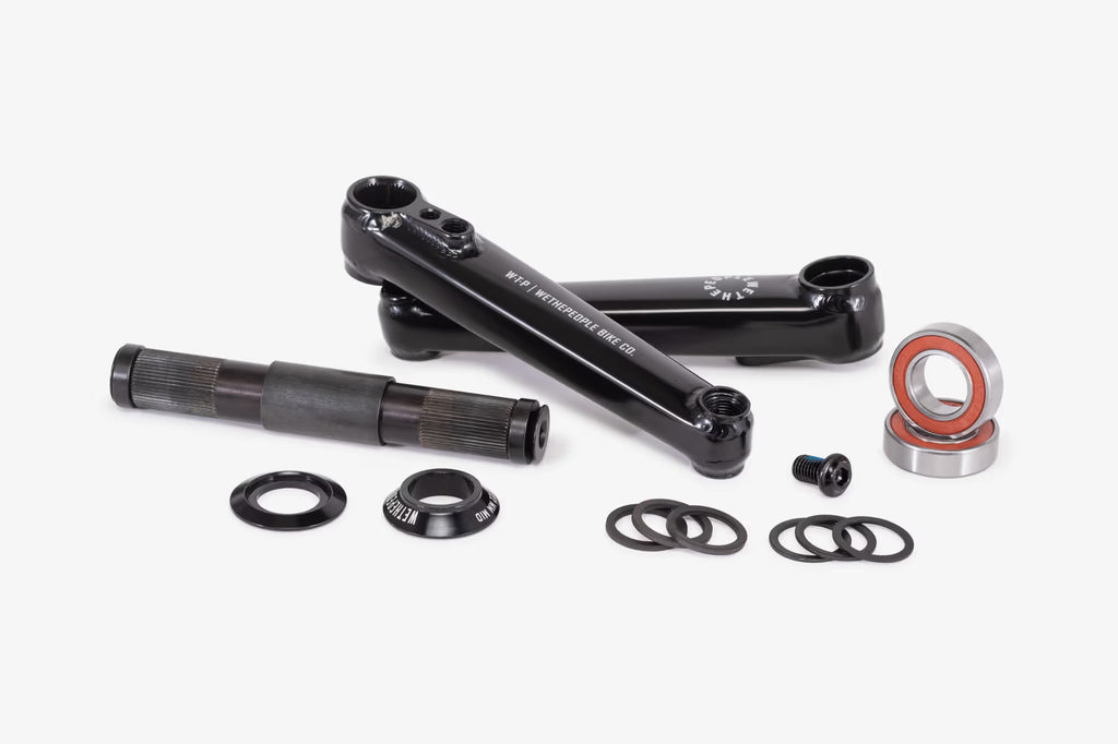 WeThePeople Logic BMX Crank Set in Black with Mid Bottom Bracket and Bearings. This image showcases a full 3-piece crankset, including durable chromoly crank arms, a 22mm spindle, and all necessary hardware for installation