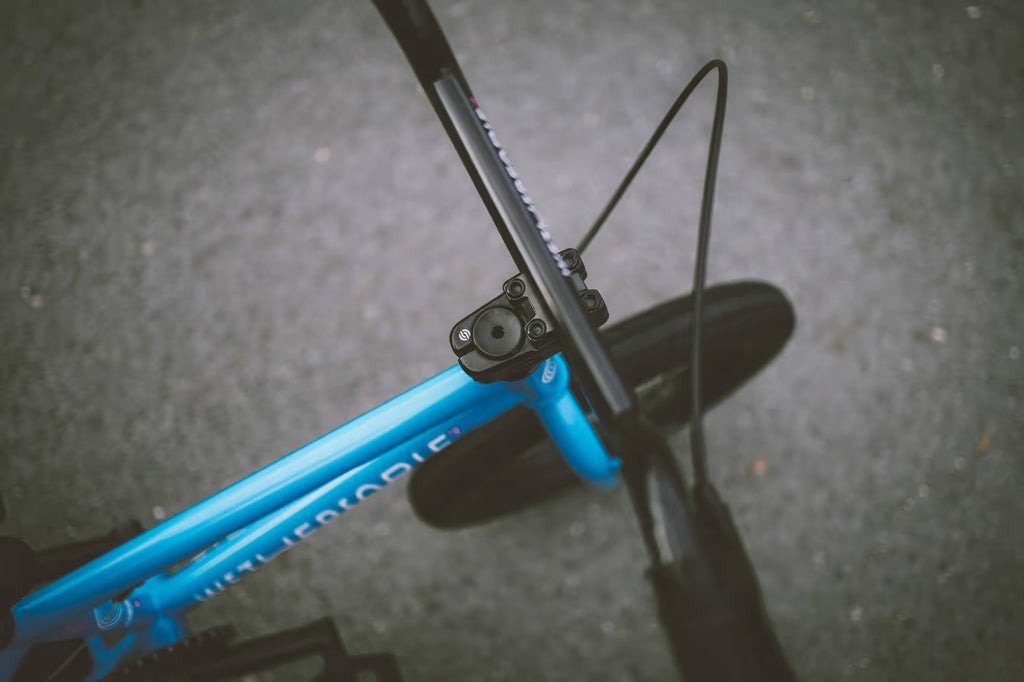 Close-up of a blue bicycle frame with a blurred background