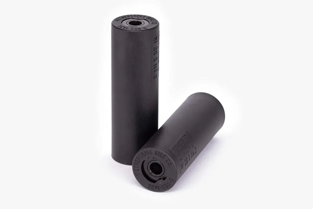Pair of Wethepeople (WTP) Temper BMX Pegs, black, showing the smooth nylon/fiberglass sleeve and the detailed metal inner core end caps.
