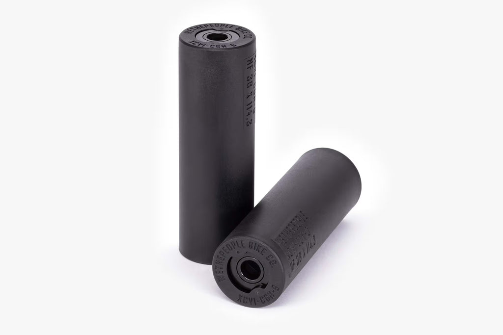 Pair of Wethepeople (WTP) Temper BMX Pegs, all-black, showing the smooth nylon/fiberglass sleeve and the metal inner core ends with WETHEPEOPLE branding.