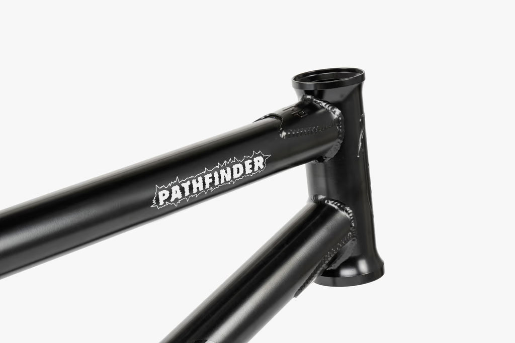 Close-up of a black We The People Pathfinder BMX frame, showing the head tube, top tube with 'PATHFINDER' branding, and front triangle welds.