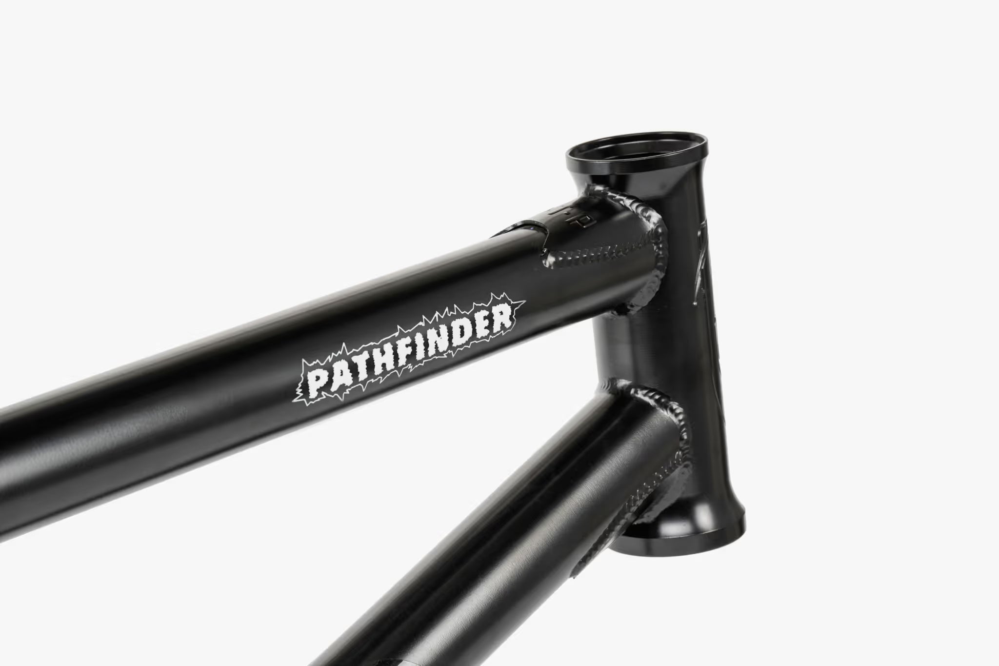 Close-up of a black We The People Pathfinder BMX frame, showing the head tube, top tube with 'PATHFINDER' branding, and front triangle welds.