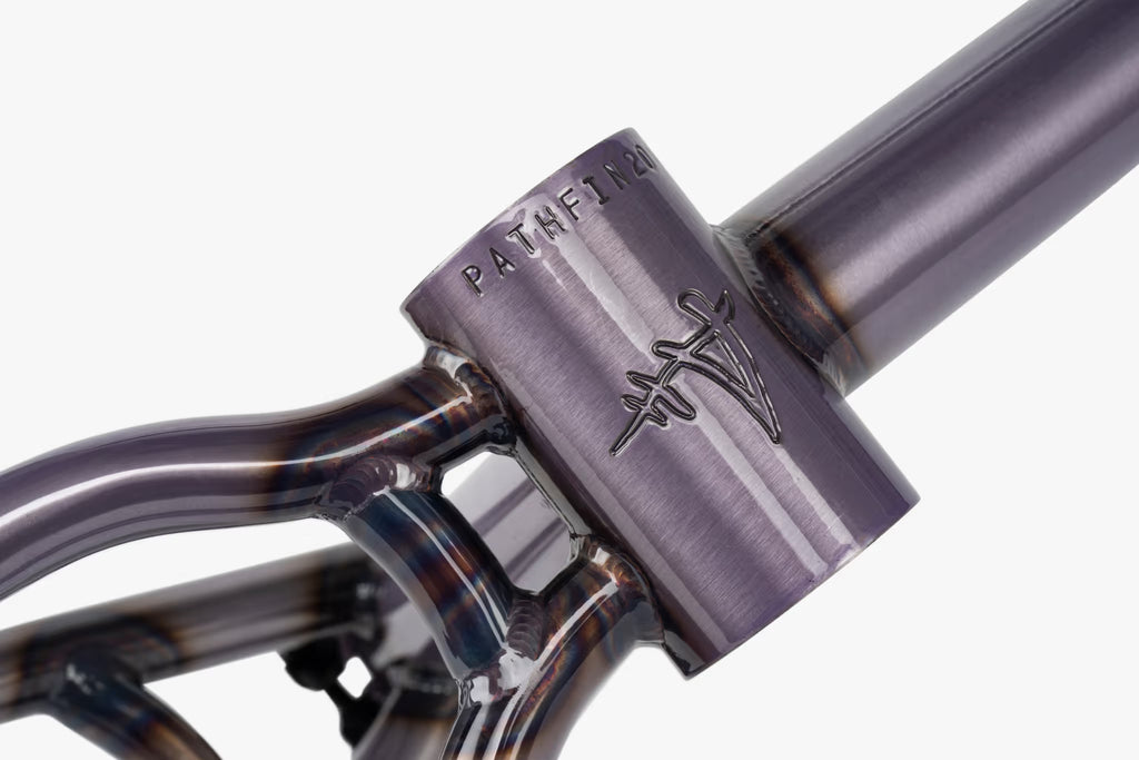 Close-up of a Wethepeople Pathfinder BMX frame's head tube and top tube, showcasing the raw or clear-coated metallic finish with visible weld details, and the distinctive Wethepeople 'W' logo with 'PATHFIN20' text debossed on the head tube