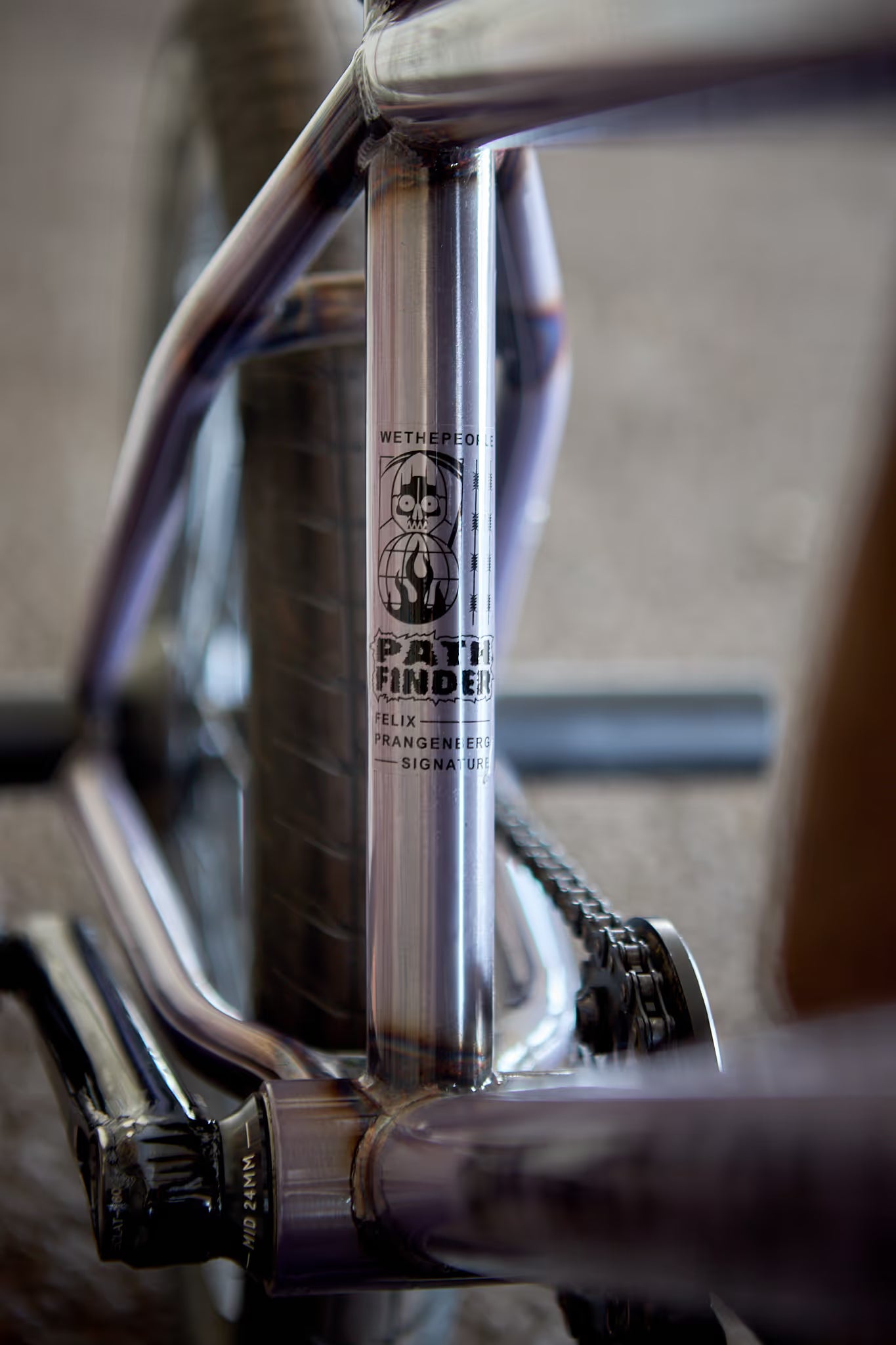 Close-up of a Wethepeople Pathfinder Felix Prangenberg signature BMX frame in a raw metal finish, featuring Wethepeople and Pathfinder branding details on the seat tube