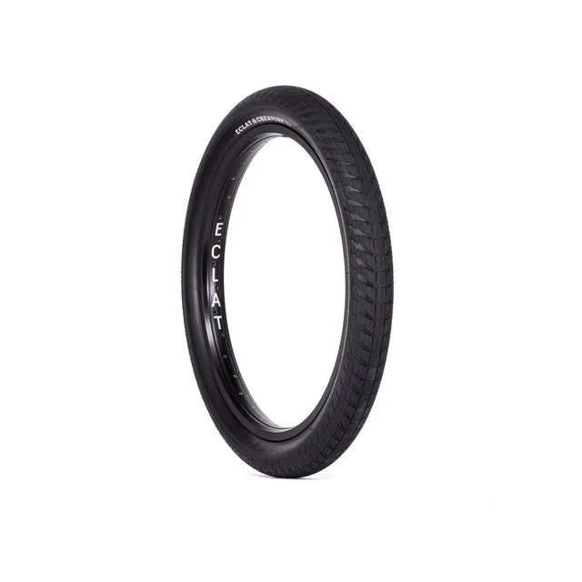 Éclat Creature BMX Tire, all-black, angled view showing the full tire profile, aggressive tread, and vertical ÉCLAT logo on the sidewall.