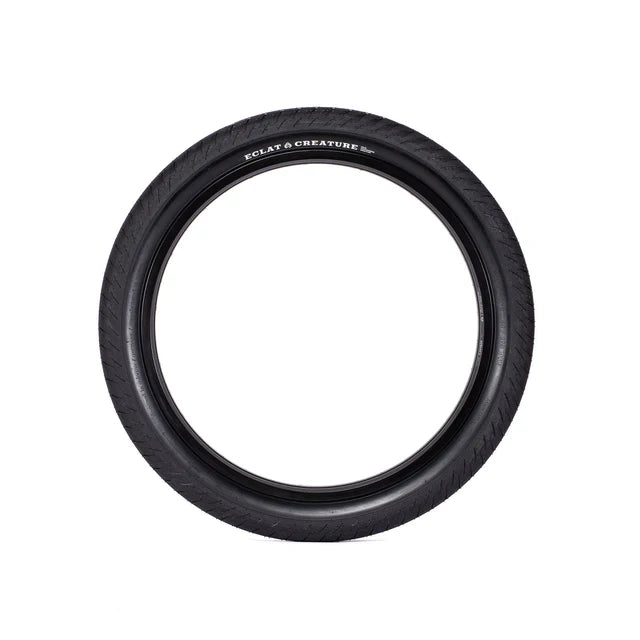 Éclat Creature BMX Tire, all-black, straight-on view showcasing the wide profile and smooth, minimalist street tread.