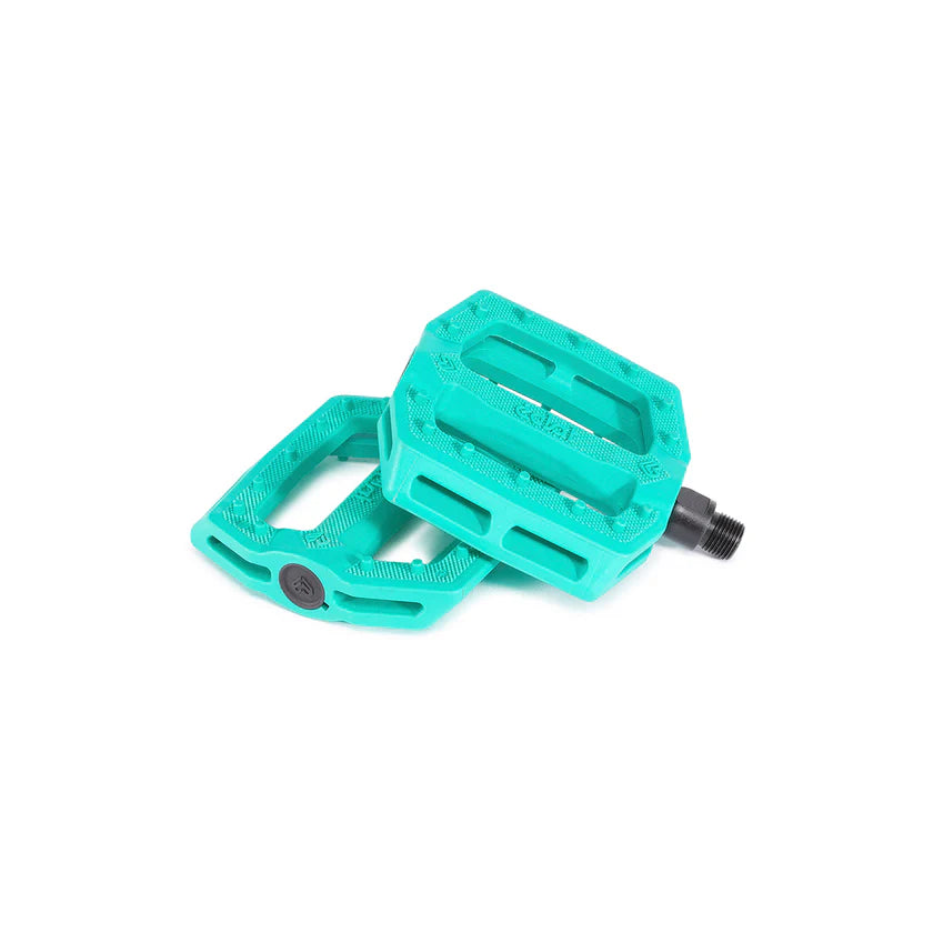 Turquoise bicycle pedals on a white background
