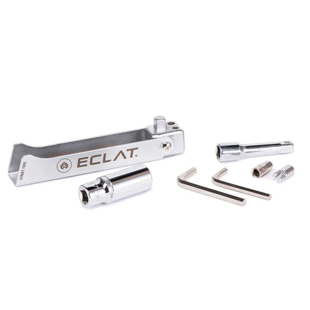 Éclat Street Tool multi-tool for BMX, completely disassembled showing the silver handle, spark plug socket, hex keys, and various adapter bits.
