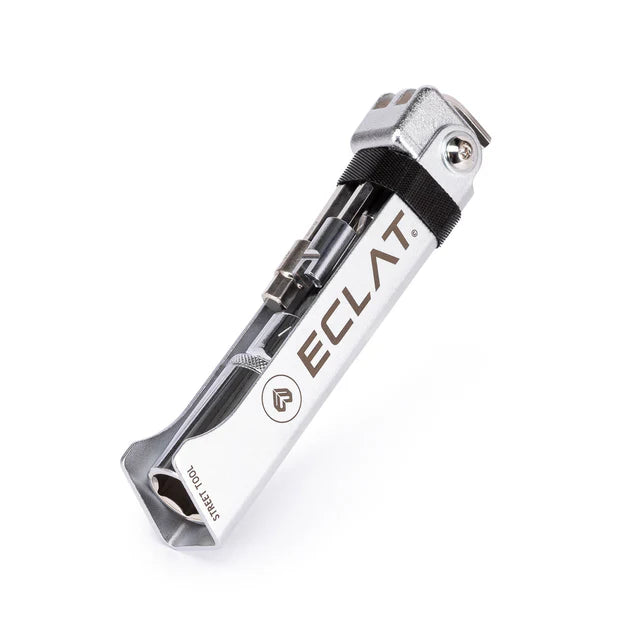 Éclat Street Tool multi-tool for BMX, closed and folded, showing the silver body, ÉCLAT branding, and bits secured by a black strap.