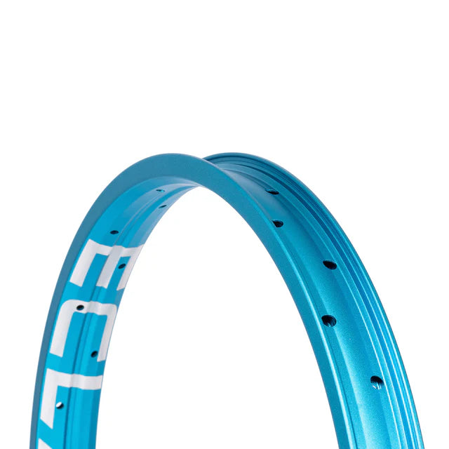 Close-up view of the Éclat Trippin BMX rim, sandblasted cyan (light blue), highlighting the double-wall profile and the bold ÉCLAT sidewall logo.