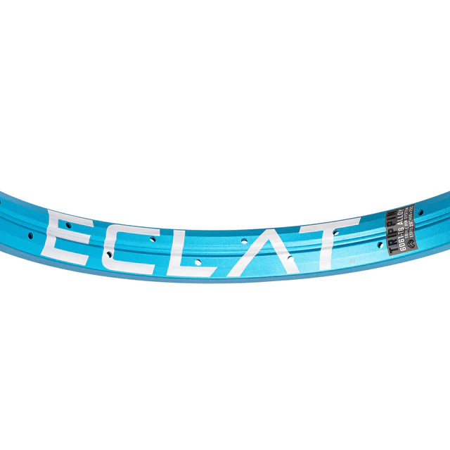 Close-up top view of the Éclat Trippin BMX rim in sandblasted cyan (light blue), showing the bold ÉCLAT sidewall logo and spoke nipple holes.