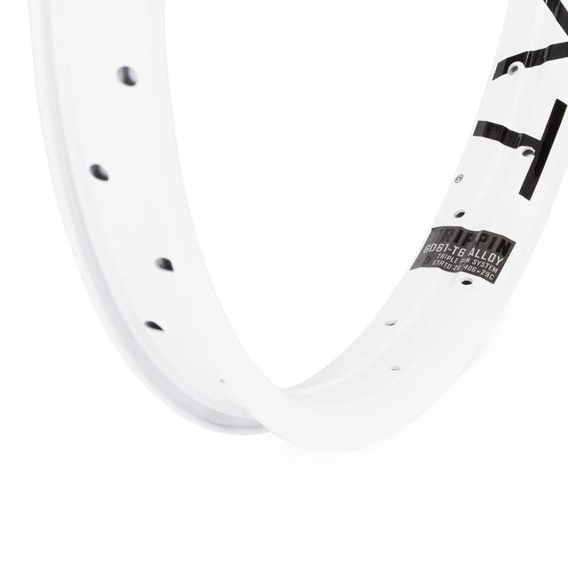 Close-up of the Éclat Trippin BMX rim in white, focusing on the decal showing the 6061-T6 alloy material and TRIPLE PIN SYSTEM construction details.