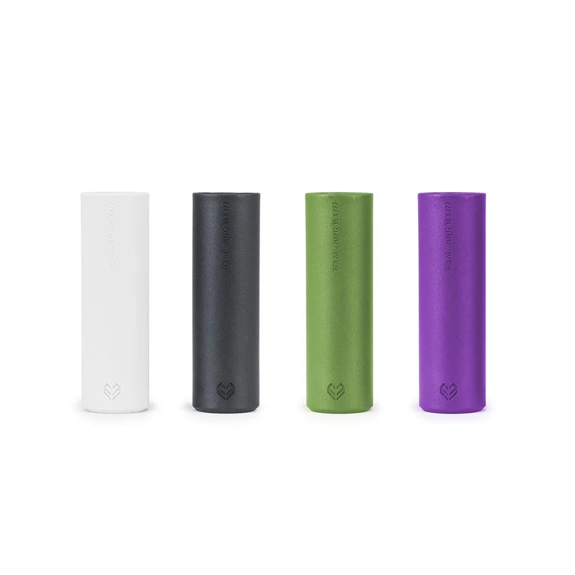 Four cylindrical products in white, black, green, and purple on a white background