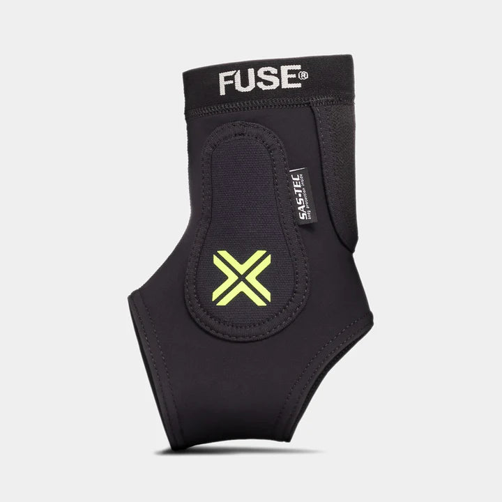FUSE Omega Ankle Protector, black, front view showcasing the SAS-TEC impact foam label and the neon yellow 'X' logo on the protective padding. (Right Side)