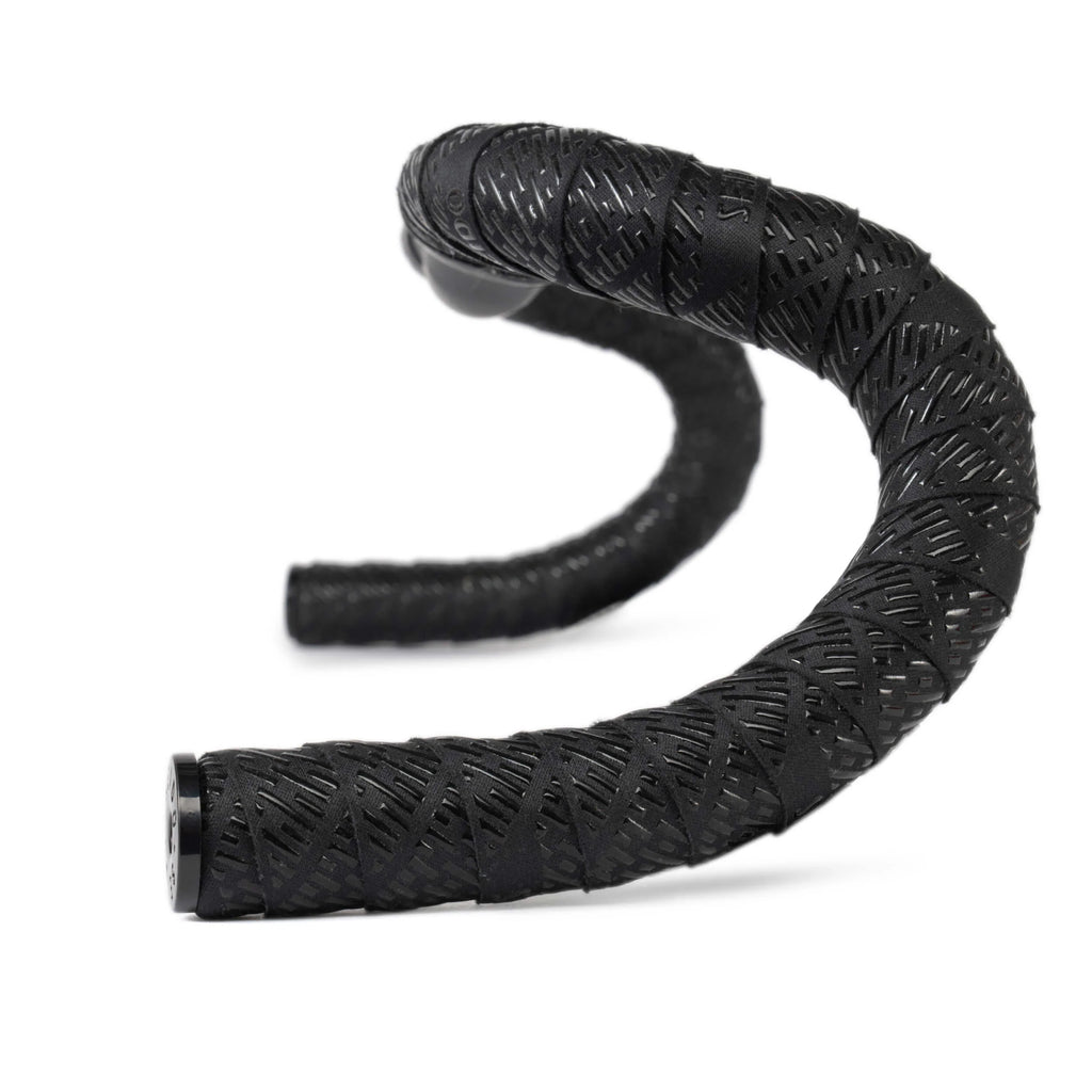 SEIDO TAB Handlebar Tape, black, shown wrapped around drop bars, highlighting the laser-cut diamond pattern for enhanced grip and texture.