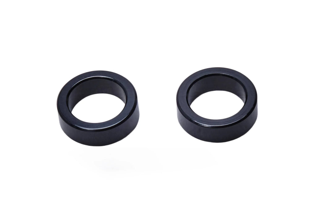 Pair of SALT EX Axle Adaptors, black, used to convert a larger axle size to a 15mm diameter for hub compatibility.