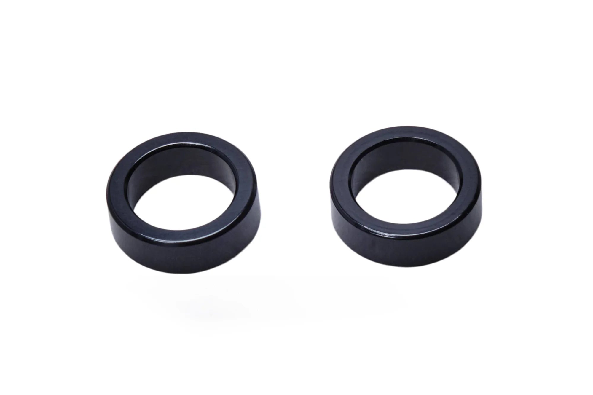 Pair of SALT EX Axle Adaptors, black, used to convert a larger axle size to a 15mm diameter for hub compatibility.