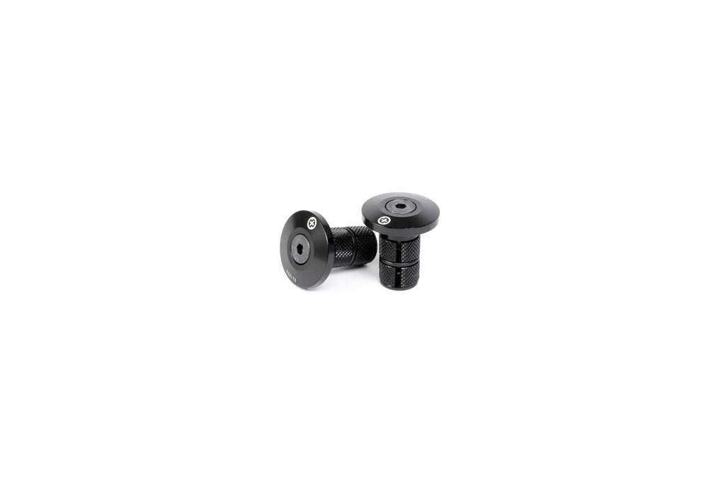 Pair of SALTPLUS HQ CNC Bar Ends, black, shown disassembled, highlighting the metal body and the knurled compression fitting for secure installation.