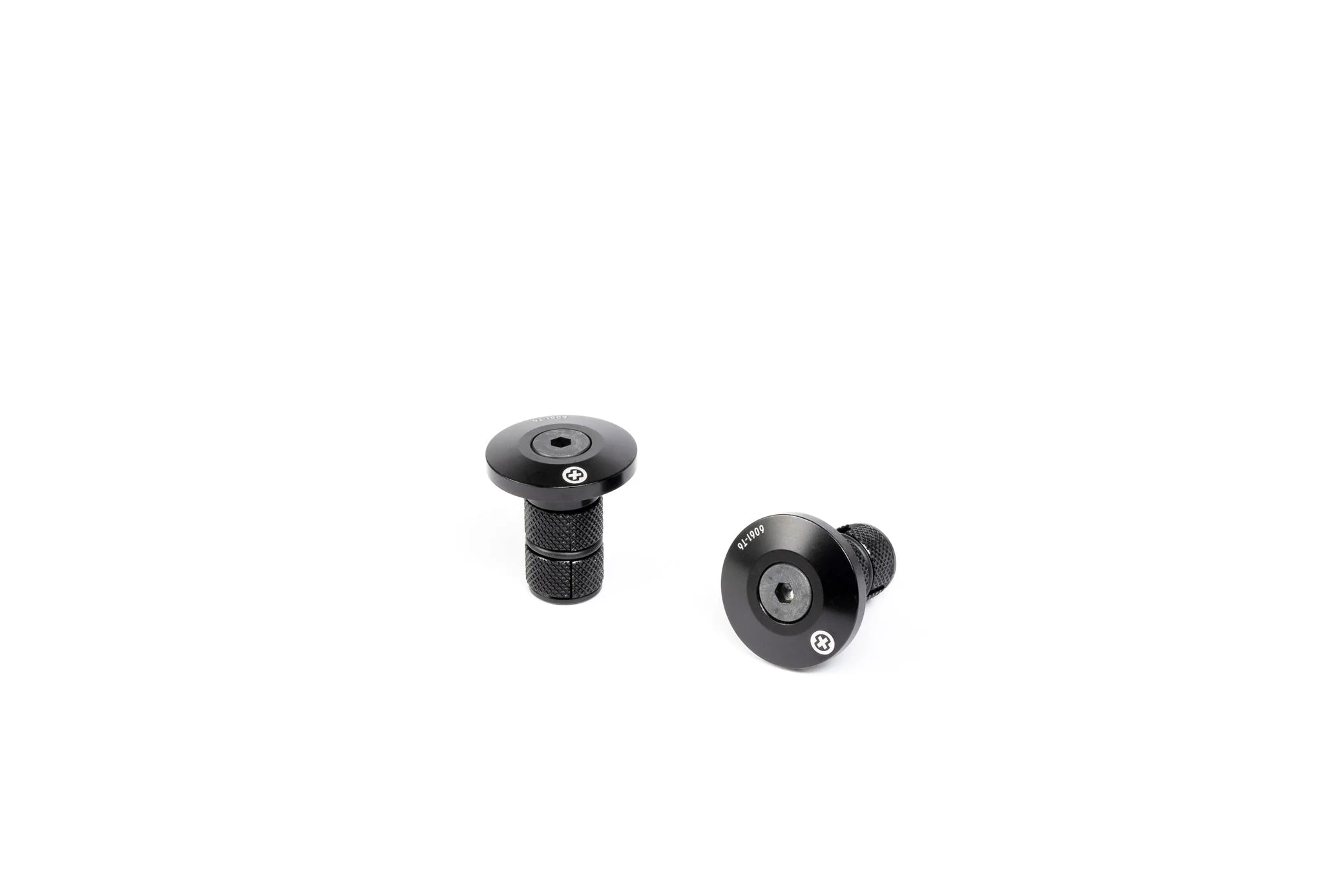 Pair of SALTPLUS HQ CNC Bar Ends, black, showing the two metal plugs with engraved logos and the knurled compression shafts.