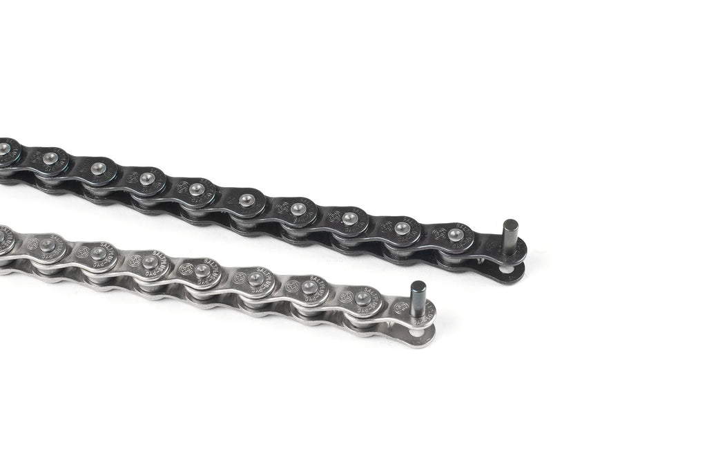 Comparison of two SALTPLUS Warlock half-link BMX chains, showing the black finish (top) and polished silver finish (bottom), with an extended pin ready for installation.
