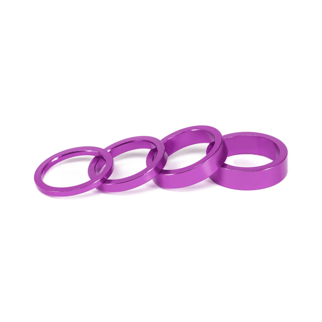 SALT BMX Headset Spacers set, featuring four different sizes of rings in a vibrant purple (anodized) finish for adjusting stem stack height.