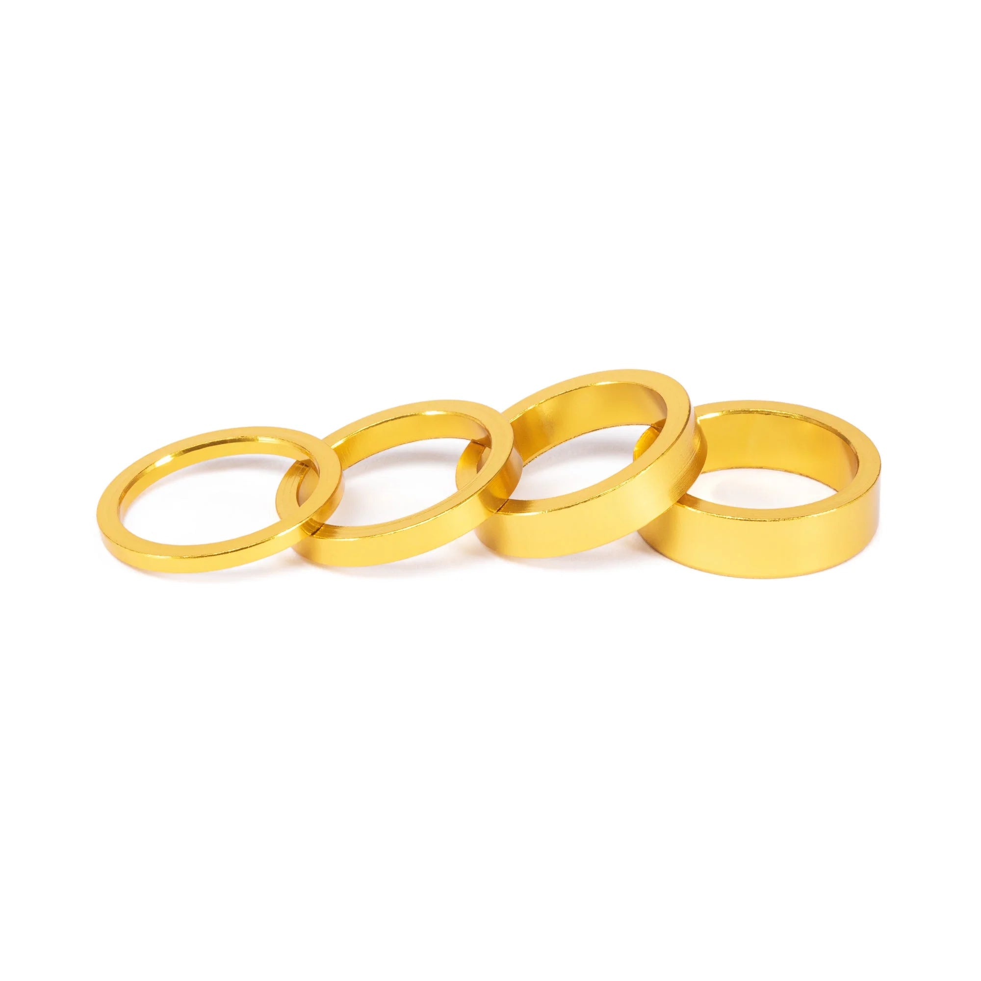SALT BMX Headset Spacers set, featuring four different sizes of rings in a bright gold finish for adjusting stem stack height.