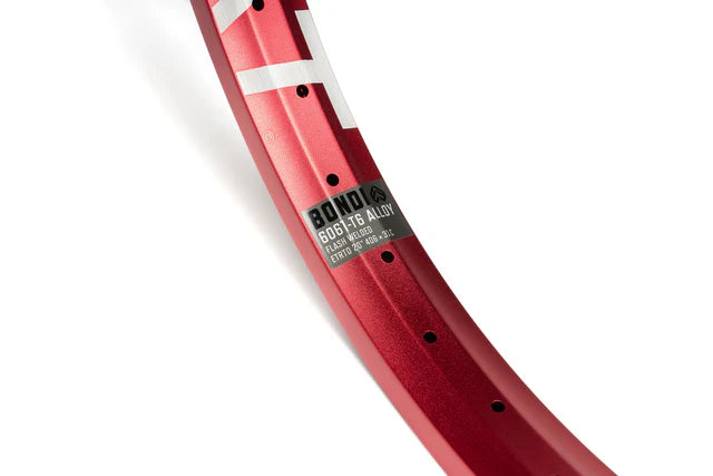 Close-up of the Éclat Bondi straight-wall BMX rim in sandblast red, focusing on the decal with 6061-T6 alloy material and Flash Welded construction details.