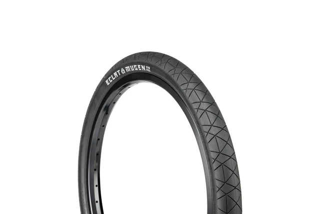 Close-up, profile view of the Éclat Mugen BMX Tire, 1.75" narrow width, all-black, showcasing the diamond-shaped street tread and ÉCLAT MUGEN branding.