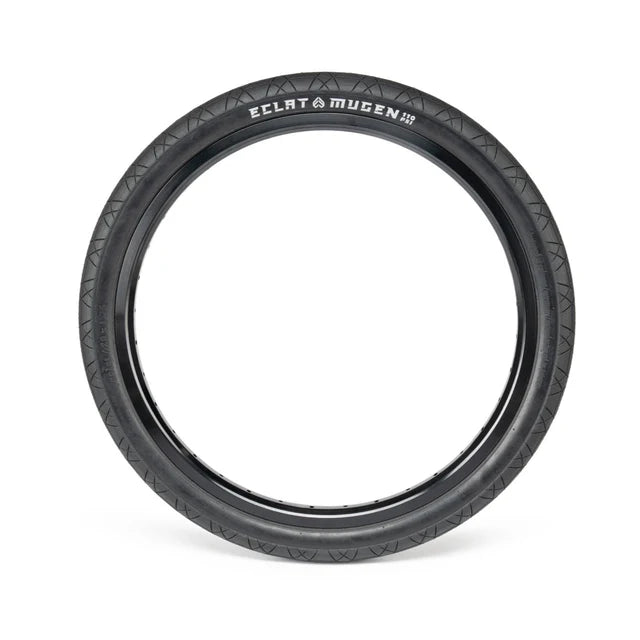 Éclat Mugen BMX Tire, all-black colorway, shown mounted on a rim, highlighting the 1.95" width and detailed tread pattern.
