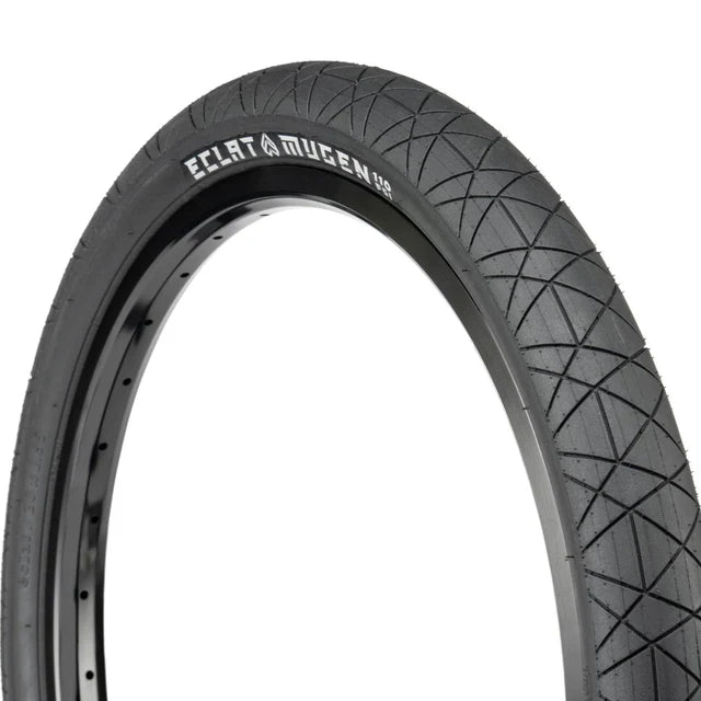 Close-up, profile view of the Éclat Mugen BMX Tire, 1.95" width, all-black, showcasing the diamond-shaped tread pattern and ÉCLAT MUGEN branding.