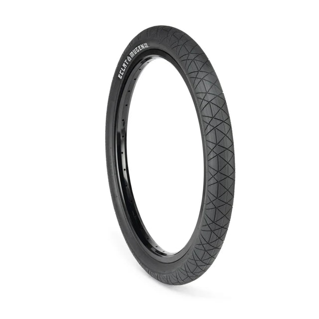 Éclat Mugen BMX Tire, all-black color, angled view showcasing the geometric street tread pattern and sidewall branding.