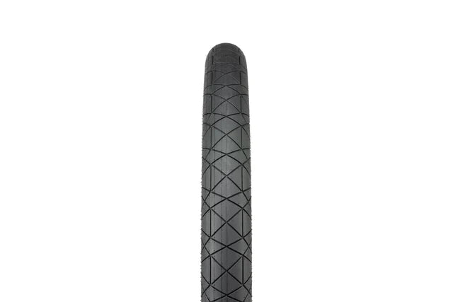 Éclat Mugen BMX Tire, 1.95" width, all-black, front-on view highlighting the minimalist street tread pattern and low-profile design