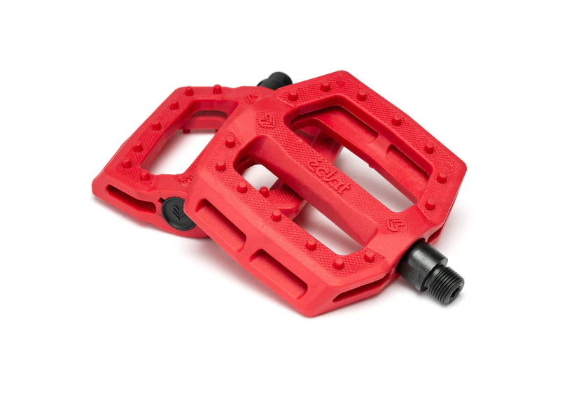 Red bicycle pedals on a white background