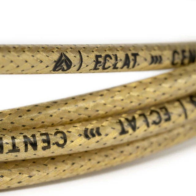 Close-up view of the Éclat 'The Center' Linear BMX Brake Cable, translucent gold, highlighting the braided housing texture and the ÉCLAT branding.