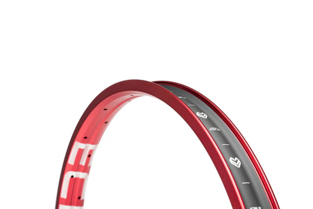 Close-up view of the Éclat Trippin double-wall BMX rim in sandblast red finish, showing the internal markings and 20 inch size on the rim bed.