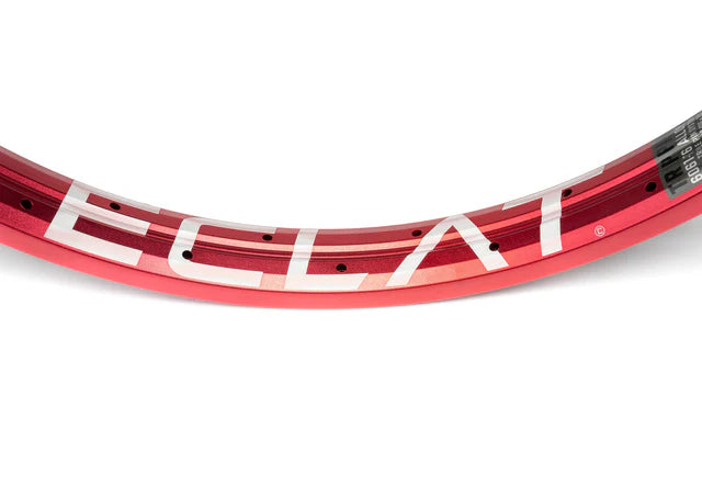 Close-up top view of the Éclat Trippin double-wall BMX rim in sandblast red, showcasing the large ÉCLAT sidewall logo and spoke holes.