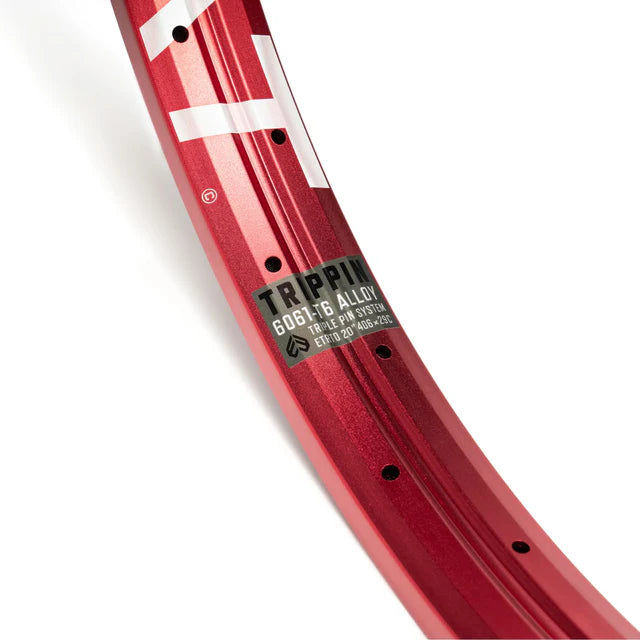 Close-up of the Éclat Trippin double-wall BMX rim in sandblast red, highlighting the decal with 6061-T6 alloy material and TRIPLE PIN SYSTEM technology.