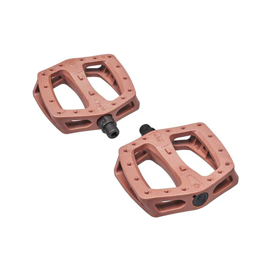 Pair of pink bicycle pedals on a white background