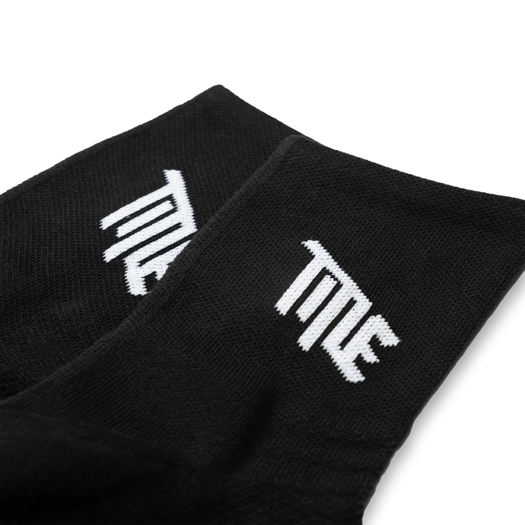 Close-up of the Title MTB logo on the side of the black sock