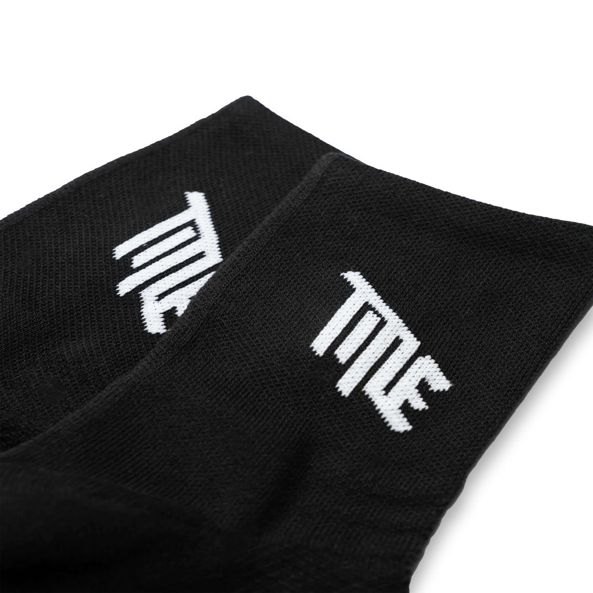 Close-up of the Title MTB logo on the side of the black sock