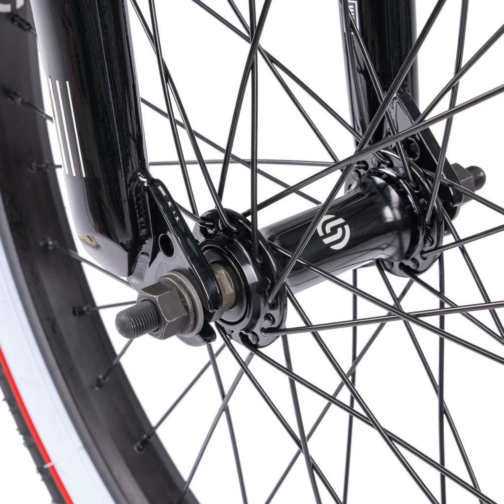 Close-up of a bicycle wheel hub with a brand logo on a white background