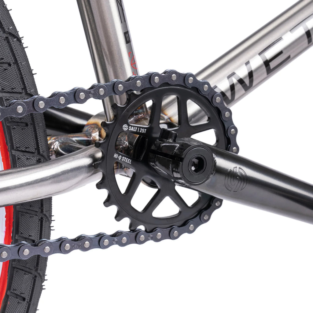 Close-up of a bicycle chain and gear system on a white background