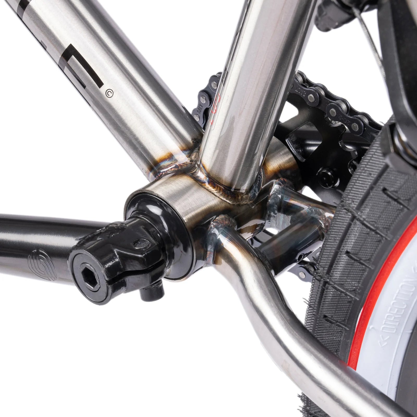 Close-up of a bicycle's chain mechanism and frame on a white background